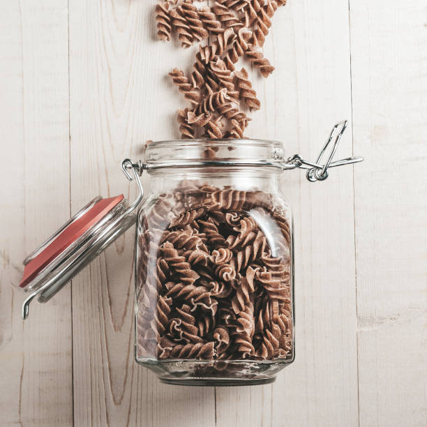 istock On a white board rustic table a glass jar with Italian pasta 1040368192