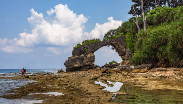 istock Neil island natural bridge rock formations with sea beach at India. 1040378846