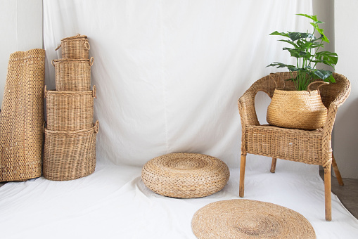 Background and texture of wicker chair and basket weave on white fabric. Decorations with tree.