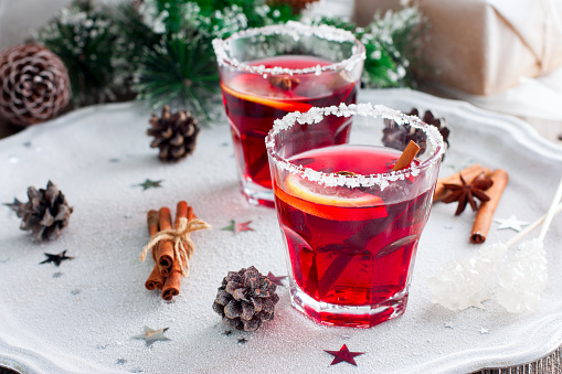 Non-alcoholic mulled wine with lemon and cinnamon in glass glasses, selective focus