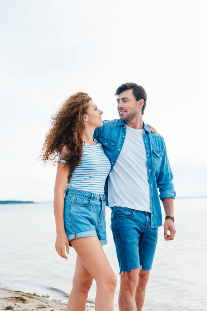 istock beautiful girlfriend and smiling boyfriend hugging on seashore 1040385398