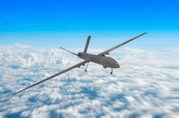 Photo of Unmanned military drone on patrol air territory at high altitude.