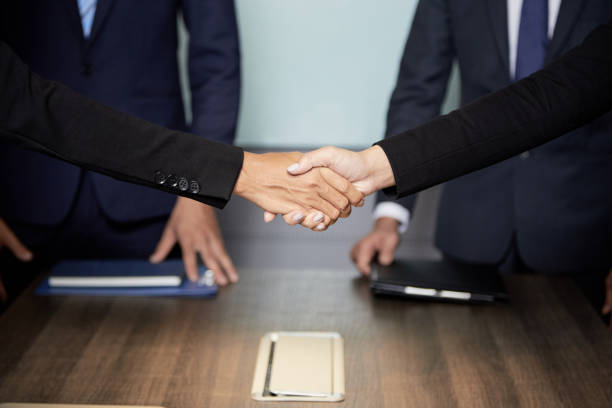 istock Crop businesspeople shaking hands 1040386106