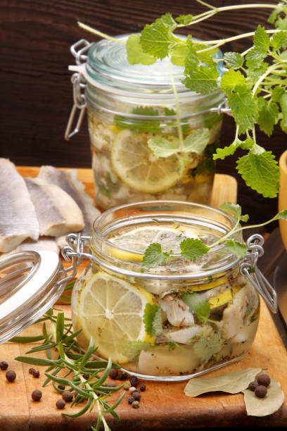 istock Healthy fresh marinated herring fillet with lemon, pepper, herbs, and onion 1040391018