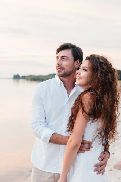 istock beautiful romantic couple hugging on seashore 1040391026