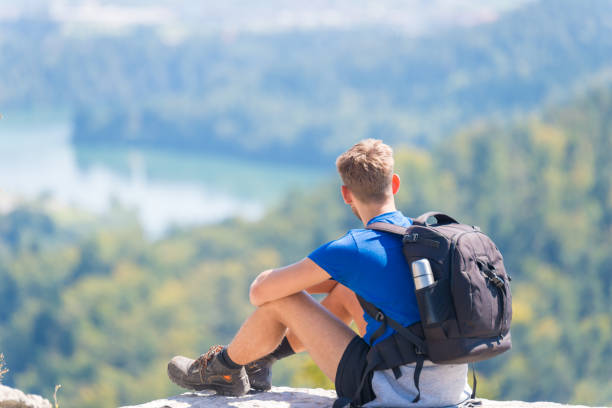 istock Happy hiker enjoy the view on mountain top rock 1040391146