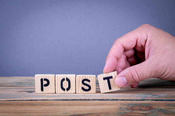 istock post. Wooden letters on the office desk 1040394178