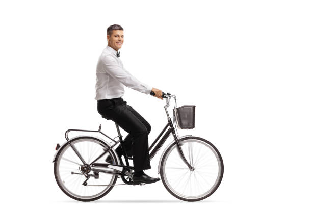 istock Handsome young man in a tux riding a bicycle 1040394488