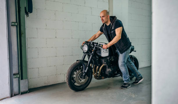 istock Man with custom motorbike leaving the garage 1040395424