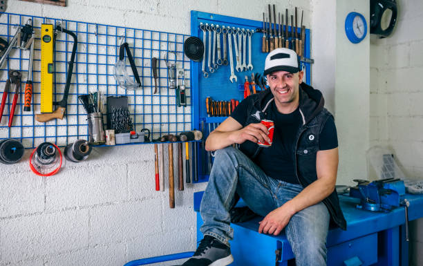 Custom motorcycles mechanic resting having a beer in his workshop