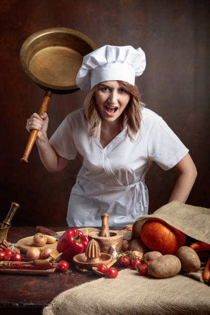 istock Very angry chef with big frying pan in hand. 1040400524