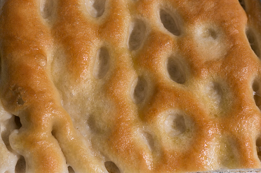 Imagen de la página de primer plano, lleno de una porción de focaccia, un pan aceitoso italiano típico de la región de liguria. photo