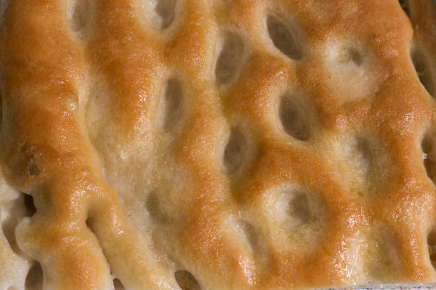 Close-up, full page image of a slice of focaccia, an italian oily bread typical of liguria region. stock photo