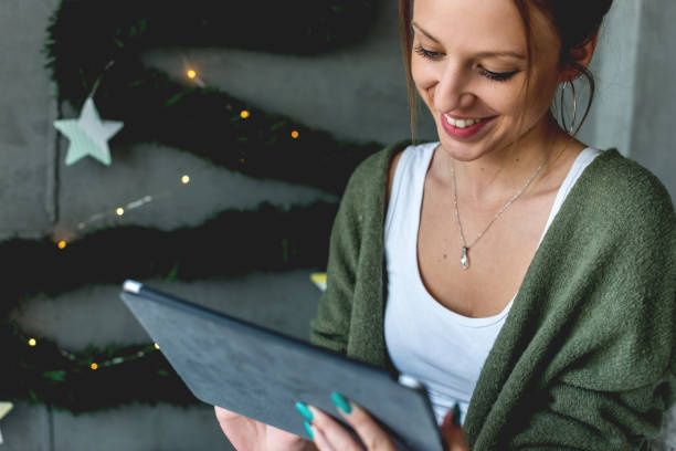 istock Smiling young woman with digital tablet 1040407502
