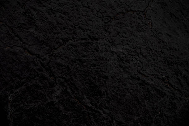 istock Close up abstract black cracked background texture of asphalt road 1040407908