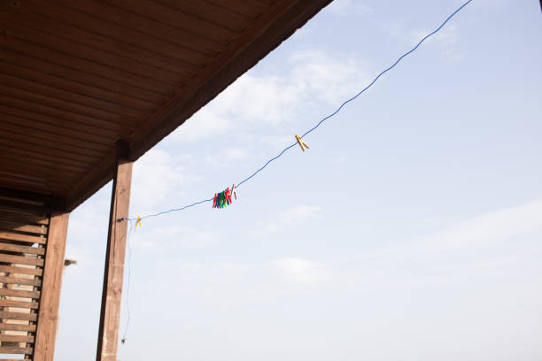 multicolored clothespins on a leash outdoors on the sky background