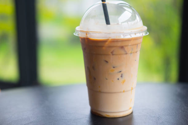 istock Ice caramel mochiato in takeaway cup on black table 1040418212