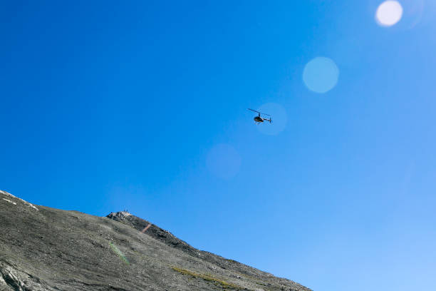 istock A helicopter in the sky above the mountains. 1040432400