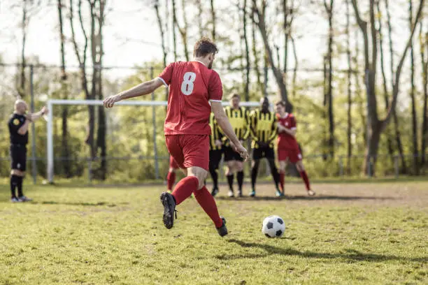 Adult Male Soccer Teams Competing for a free kick during a match