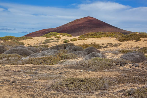 istock Picturesque red volcano illuminated by sunlight 1040439662