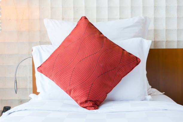 istock Modern bedroom interior with red pillow on white bed 1040440874
