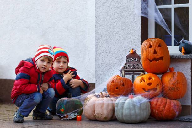 istock Two kid boys with pumpkins on halloween evening 1040444516