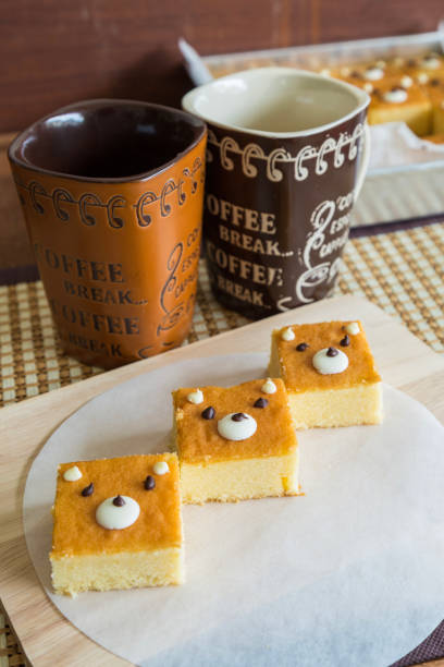 istock Tree butter cakes on wooden chopping board with coffee cups. 1040444976