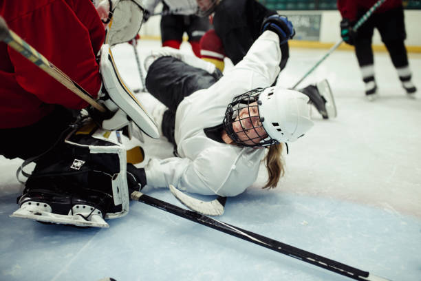 Female Ice Hockey Player Sliding after Tackle