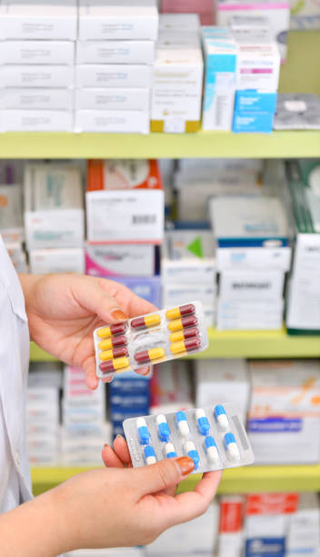 istock Pharmacist holding medicine capsule pack 1040451590