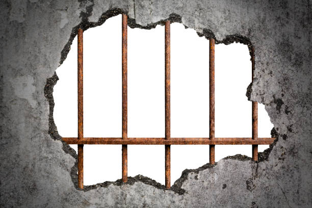istock Broken old grunge wall with old prison rusted metal bars on white with clipping path 1040451640