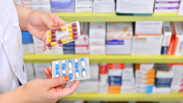 istock Pharmacist holding medicine capsule pack 1040453904