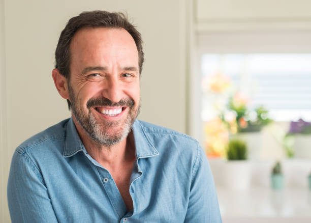 istock Handsome middle age man with a happy face standing and smiling with a confident smile showing teeth 1040454342