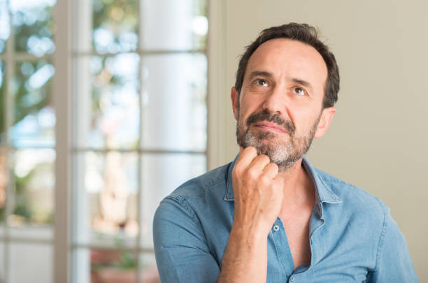 istock Handsome middle age man serious face thinking about question, very confused idea 1040454516