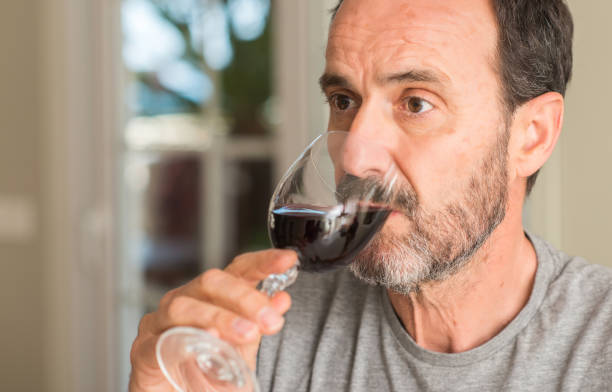 istock Middle age man drinking a glass of wine with a confident expression on smart face thinking serious 1040459132