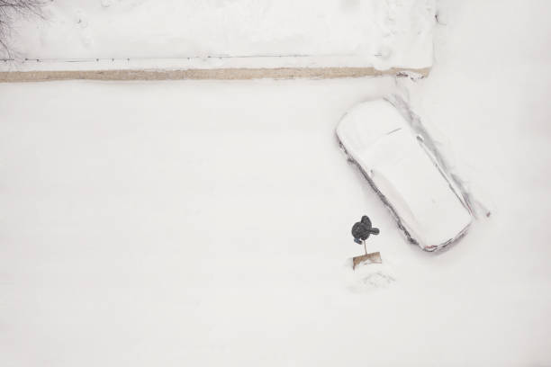 istock janitor cleans the snow-covered parking space during the snow season. 1040459352