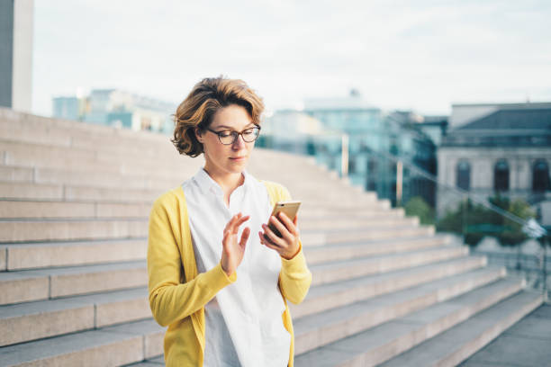 istock Caucasian woman using smartphone outdoors 1040460066