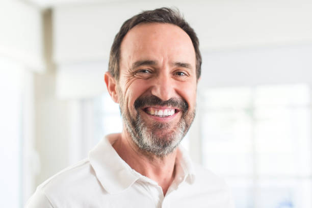 istock Handsome middle age man with a happy face standing and smiling with a confident smile showing teeth 1040460338