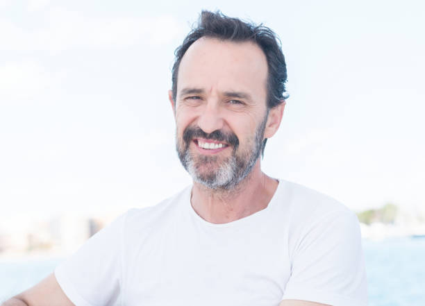 istock Middle age man smiling while sailing on beat, sea views 1040460694