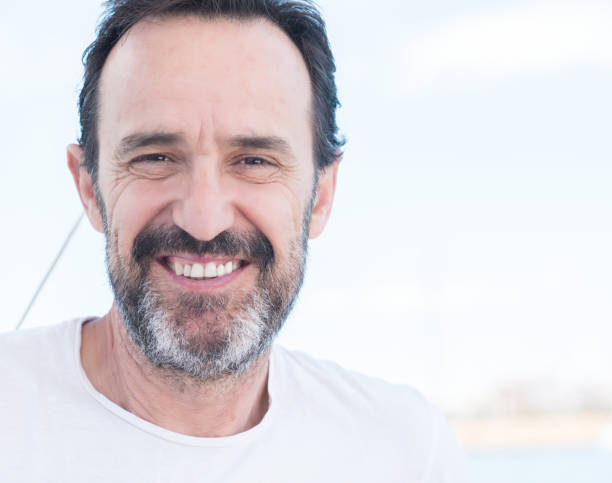 istock Middle age man smiling while sailing on beat, sea views 1040460854