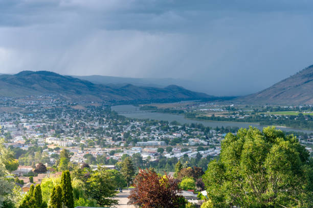 Stormy Sky over a Valley on Summer Day Stormy Clouds Looming over a Mountain Town on a Summer Day. Kamloops, BC, Canada. kamloops stock pictures, royalty-free photos & images