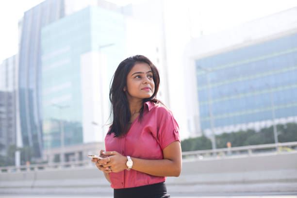 Businesswoman text messaging on mobile phone