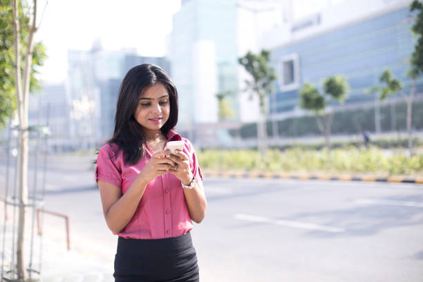 istock Businesswoman text messaging on mobile phone 1040465436