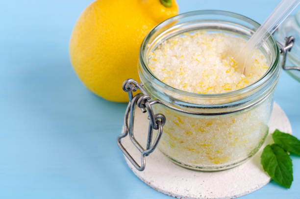Homemade sugar scrub with olive oil, essential lemon oil and lemon peel. Diy cosmetics.  Copy space. Homemade sugar scrub with olive oil, essential lemon oil and lemon peel. Diy cosmetics.  Copy space. bath salt photos stock pictures, royalty-free photos & images
