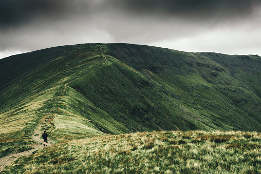 A man on the Fairfield Horseshoe trail in the Lake District