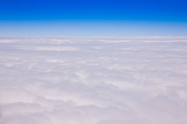 istock Bird eye view white cloudy and clear blue sky beside airplane engine 1040468910