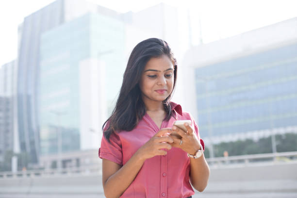 istock Businesswoman text messaging on mobile phone 1040469420