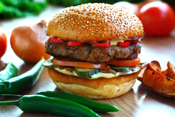 istock Juicy, spicy burger with beef and red pepper, on a table with vegetables 1040480568