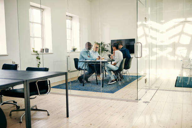 istock Diverse group of businesspeople sitting in a boardroom discussing work 1040495140