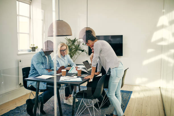 istock Diverse young businesspeople going over paperwork together in an office 1040496676
