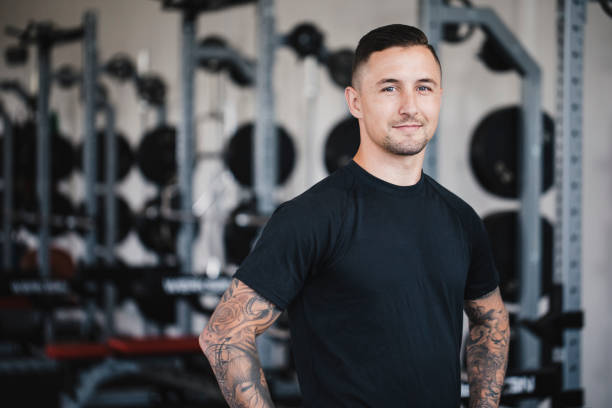 Portrait of a Personal Trainer in the Gym Portrait of a male personal trainer in the gym. fitness instructor stock pictures, royalty-free photos & images